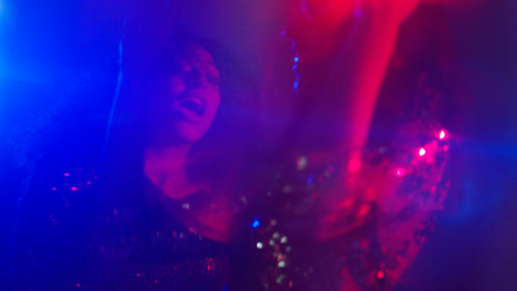 Close-Up-Of-Two-Women-In-Nightclub-Bar-Or-Disco-Dancing-With-Sparkling-Lights-6